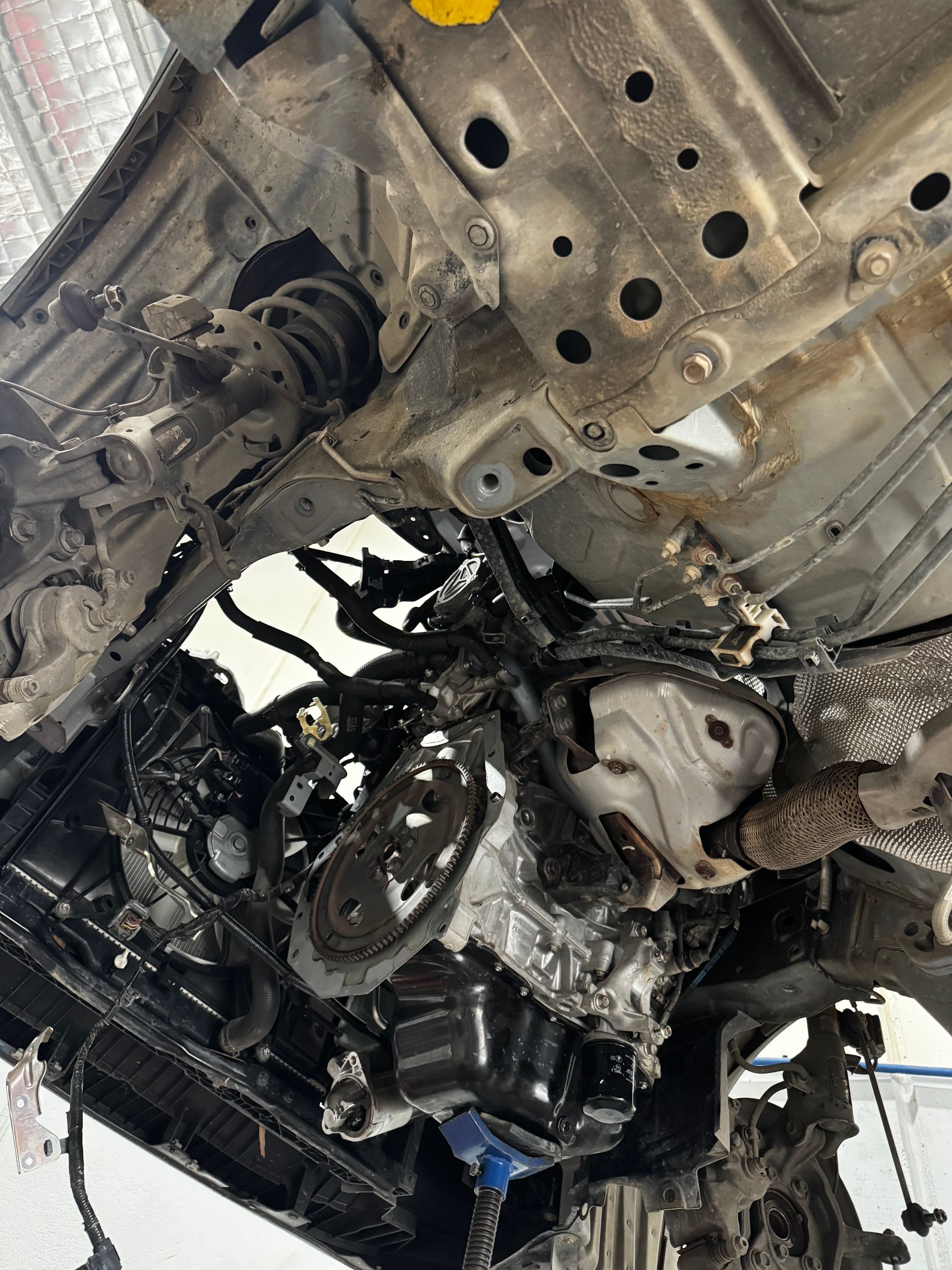 An Underside View Of A Vehicle Lifted In A Garage — Elite Fleet Auto - Electrics & Mechanical in Mackay, QLD