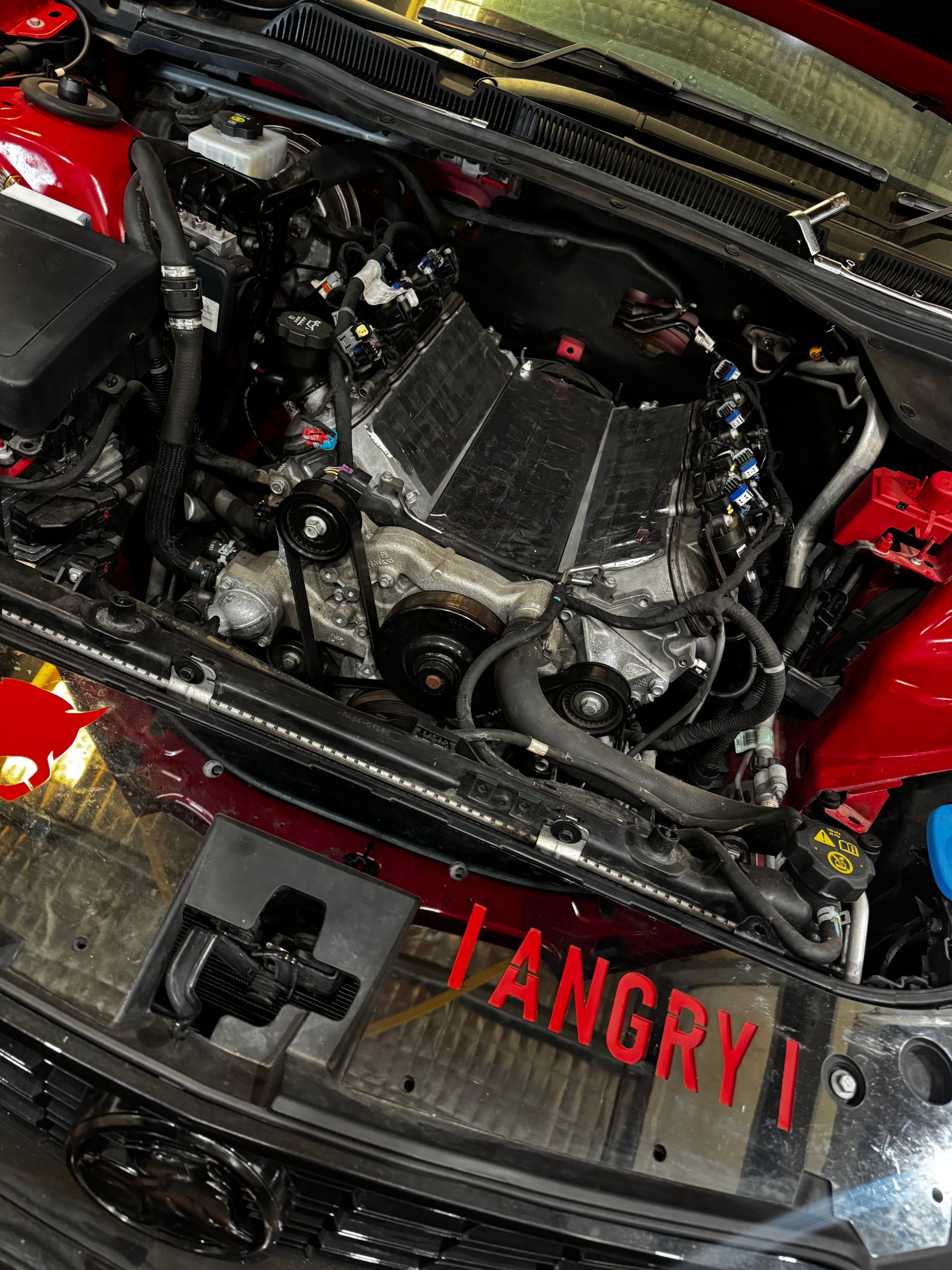 Engine Bay Of A Red Car With A Metallic Engine — Elite Fleet Auto - Electrics & Mechanical in Bowen, QLD