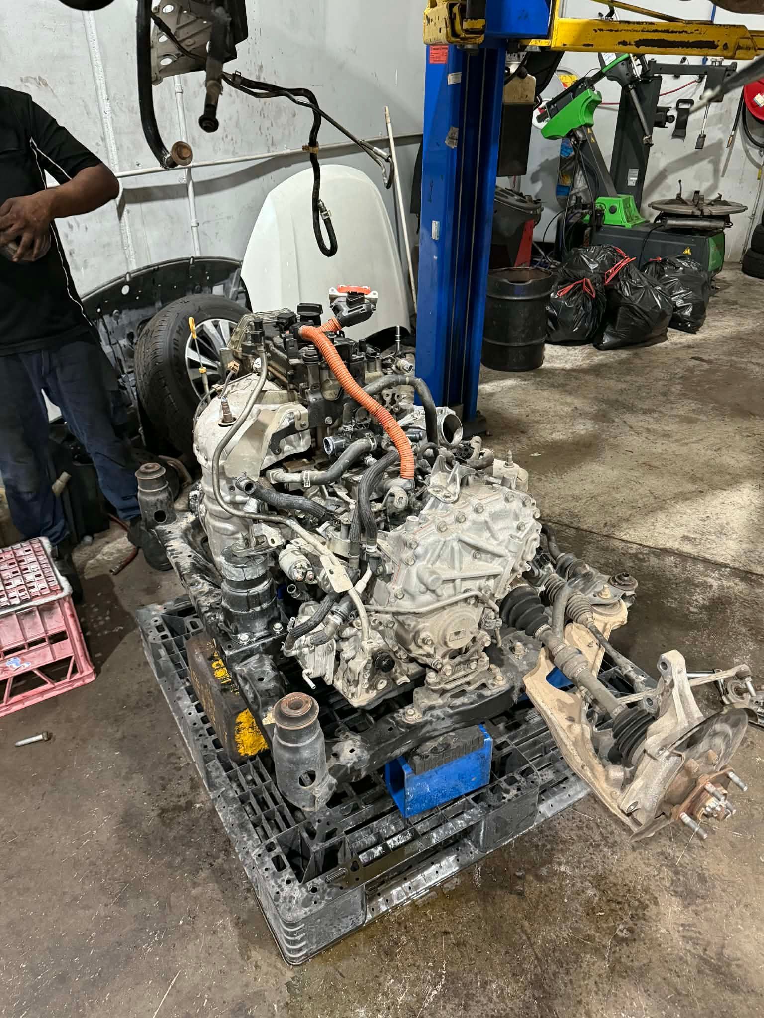 A Large Car Engine Sits On A Black Pallet Inside A Mechanical Garage — Elite Fleet Auto - Electrics & Mechanical in Cannonvale, QLD