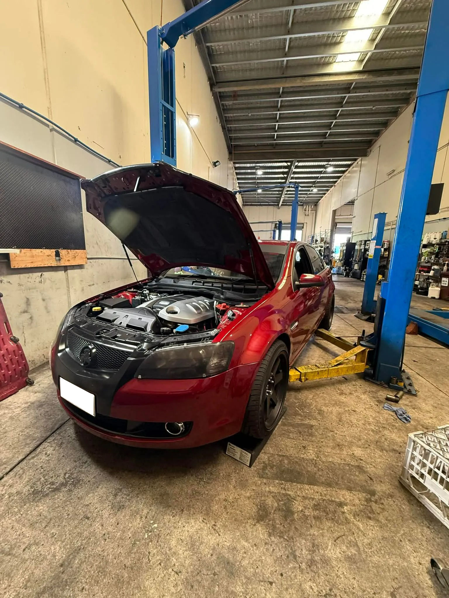 A Red Car With Its Hood Open, Parked In A Professional — Elite Fleet Auto - Electrics & Mechanical in Cannonvale, QLD