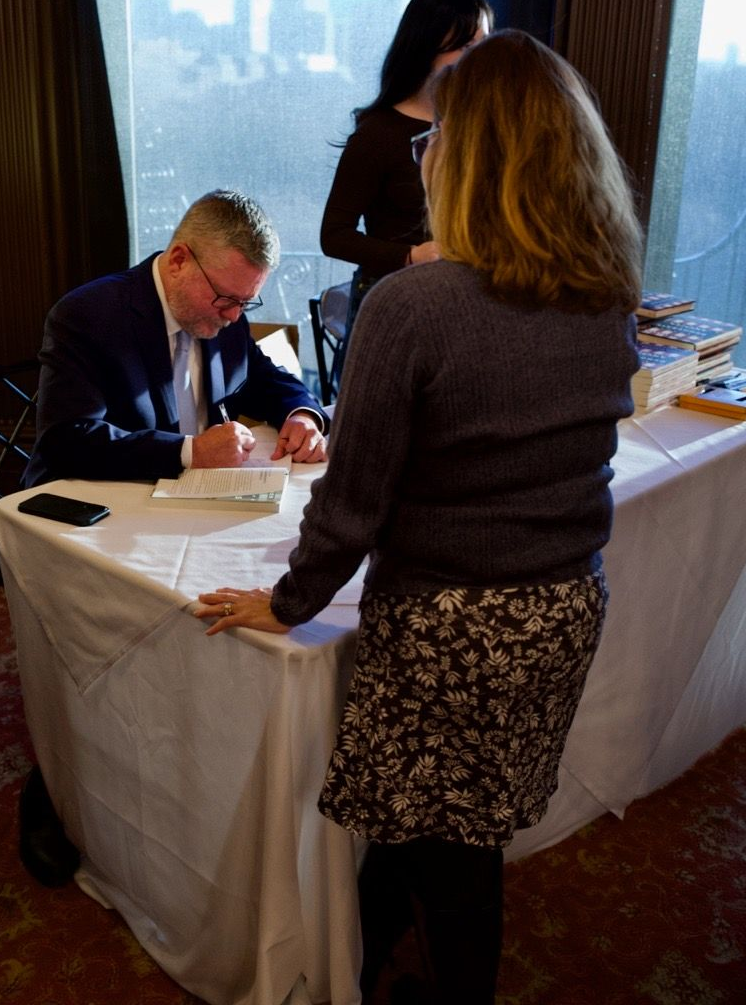 Scott Ferson signing his book at the launch party on April 8th. 