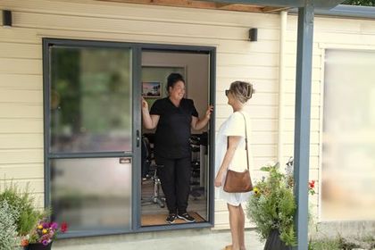 Dana greets client at the open door at Enhance beauty spa Makarau Rodney 