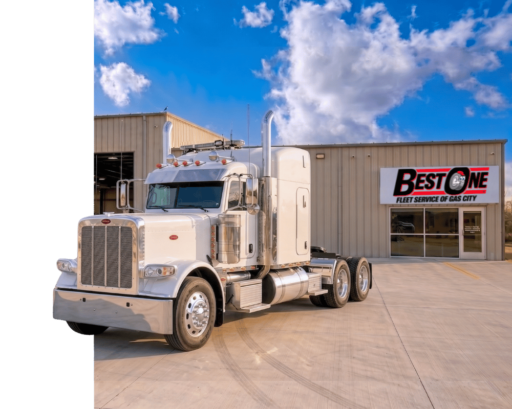 White semi truck parked outside Best One Fleet Service of Gas City shop under a blue sky.