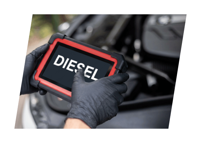 Technician using a diagnostic tablet to scan and troubleshoot a diesel engine with the hood open.