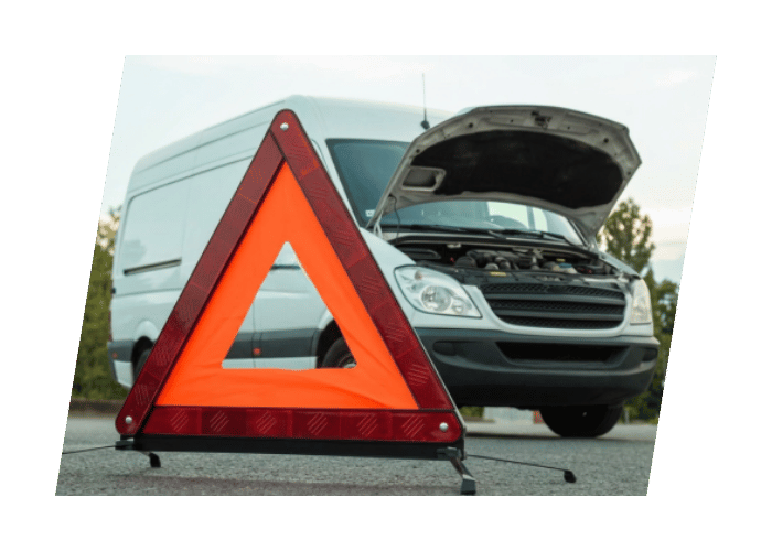 Warning triangle placed behind a commercial cargo van with the hood open during a roadside breakdown.