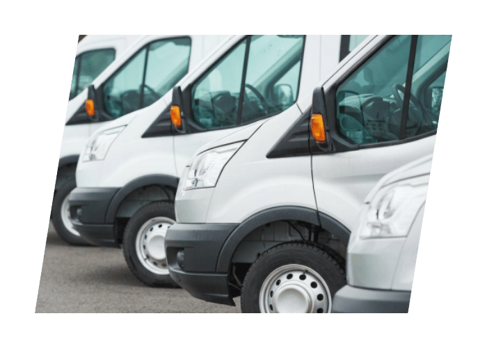 Row of white commercial cargo vans parked together as part of a fleet ready for service.