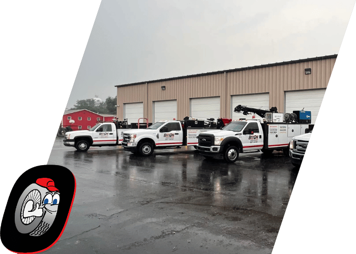 Fleet of commercial utility trucks parked outside a service facility ready for dispatch.
