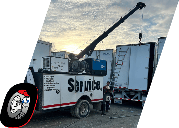 Mobile service truck performing on site commercial vehicle repairs beside a box truck.
