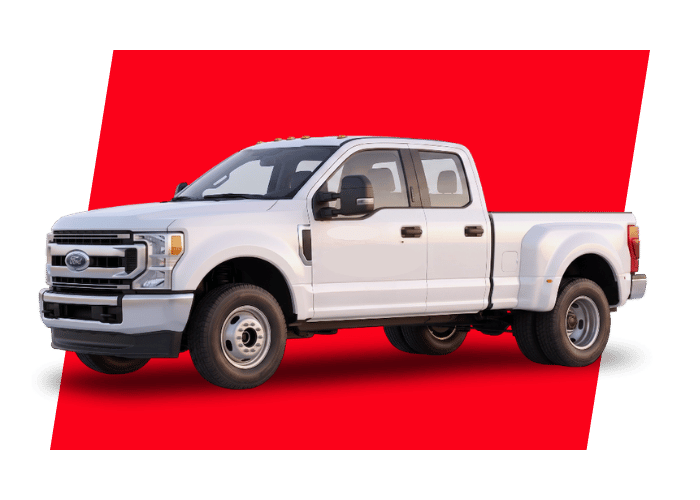 White crew cab super duty pickup truck with dual rear wheels built for towing and heavy workload applications.