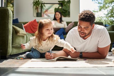 Father and daughter bonding in the living room.