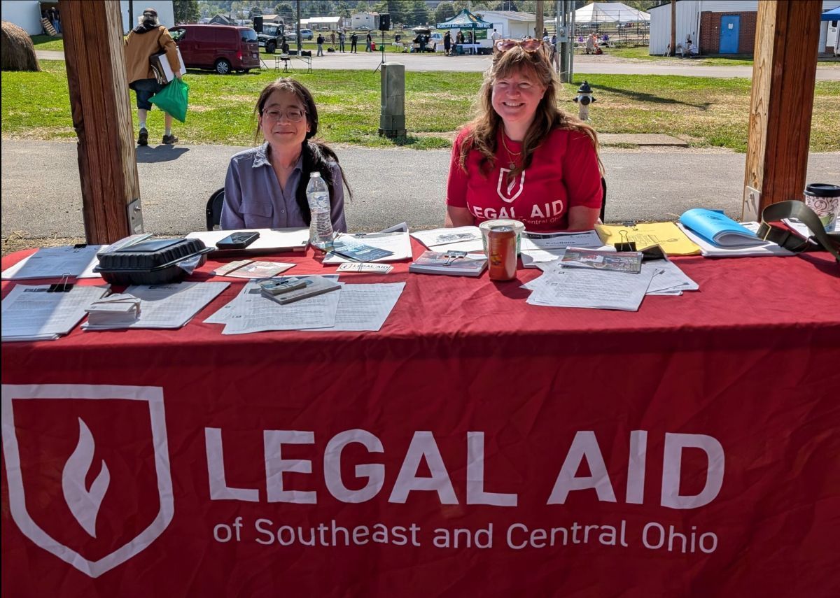 LASCO attorneys Peggy Lee and Lucy Schwallie smile for a picture at a LASCO resource table