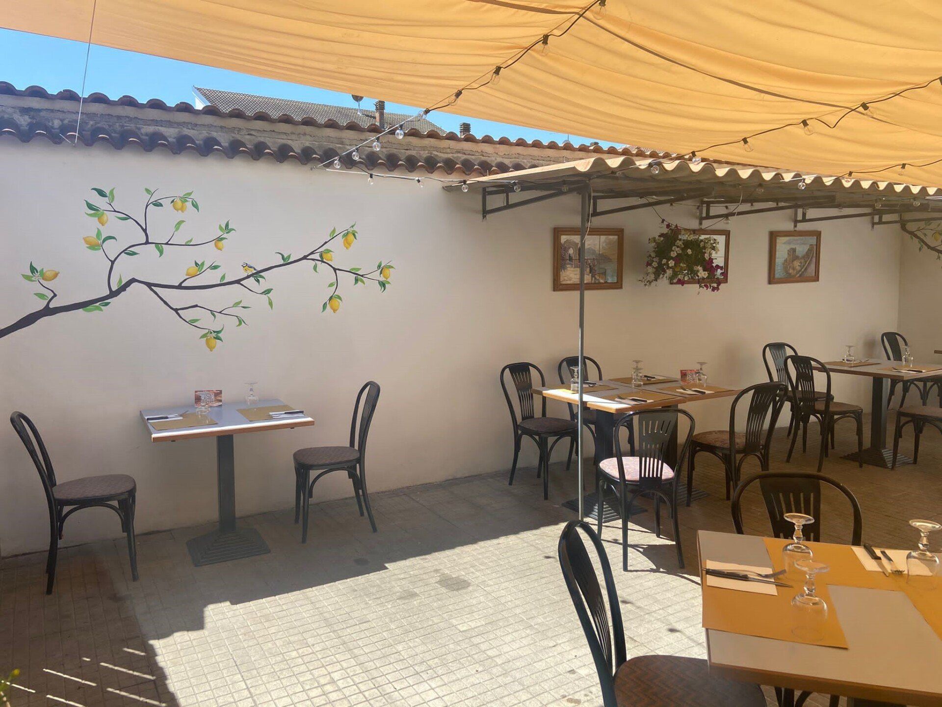 Un ristorante con tavoli e sedie sotto un ombrellone