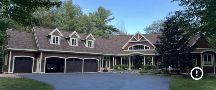 Lakeland Roofing crew on a completed residential roofing project in Minocqua, WI.