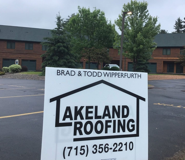 Lakeland Roofing family-owned crew at a completed residential roofing project in Minocqua, WI.