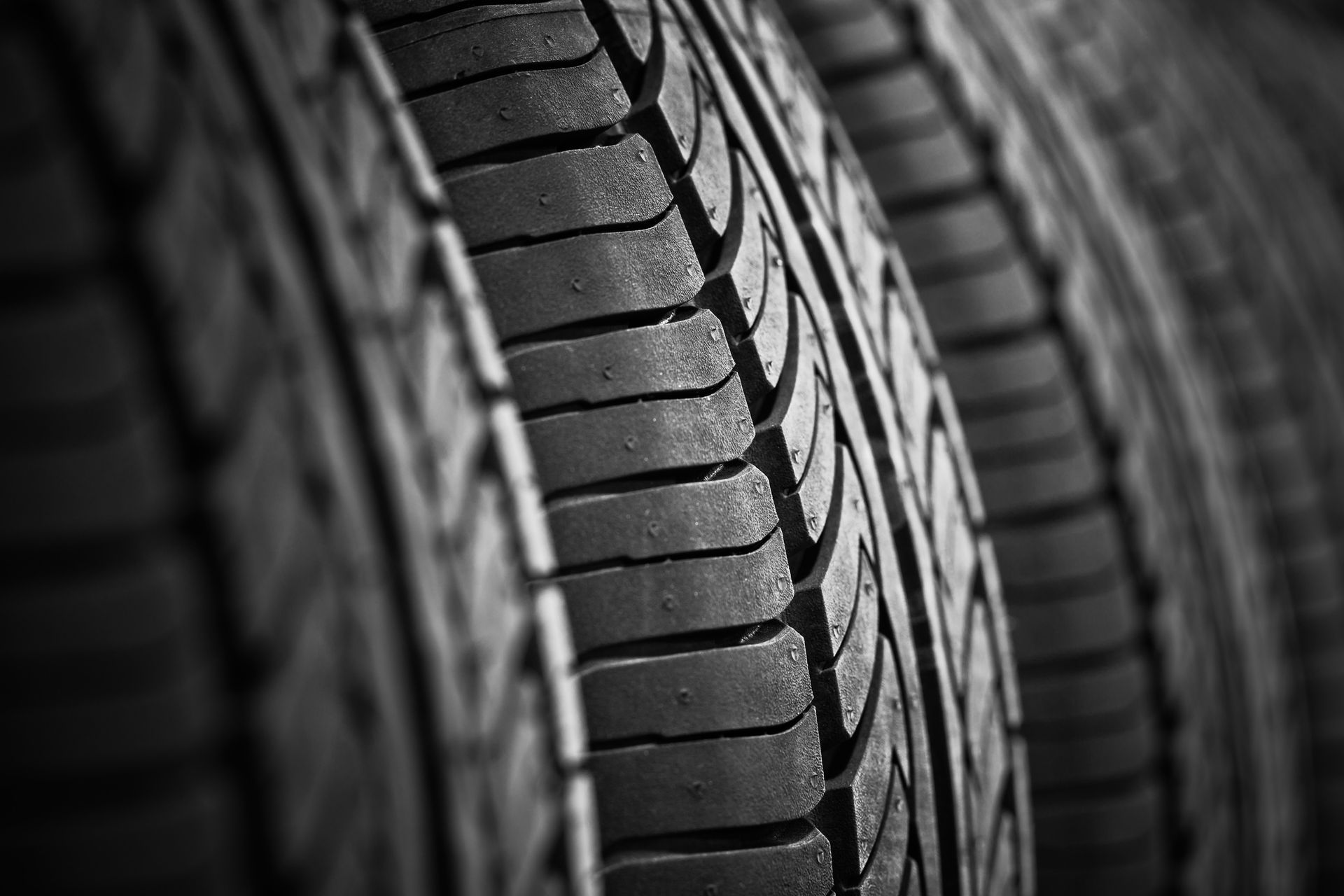 A black and white photo of a stack of tires.