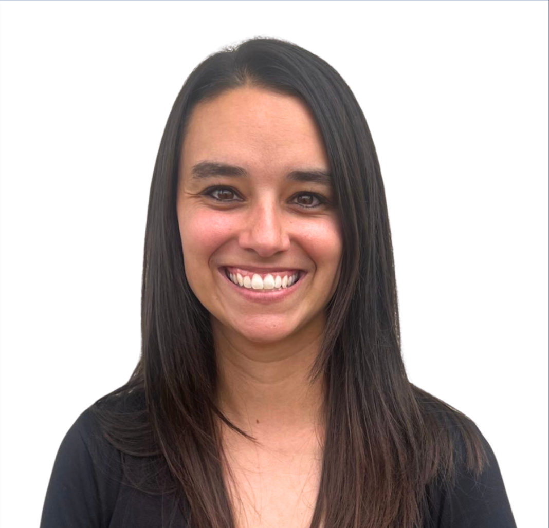 A woman with long hair is smiling and wearing a black shirt.