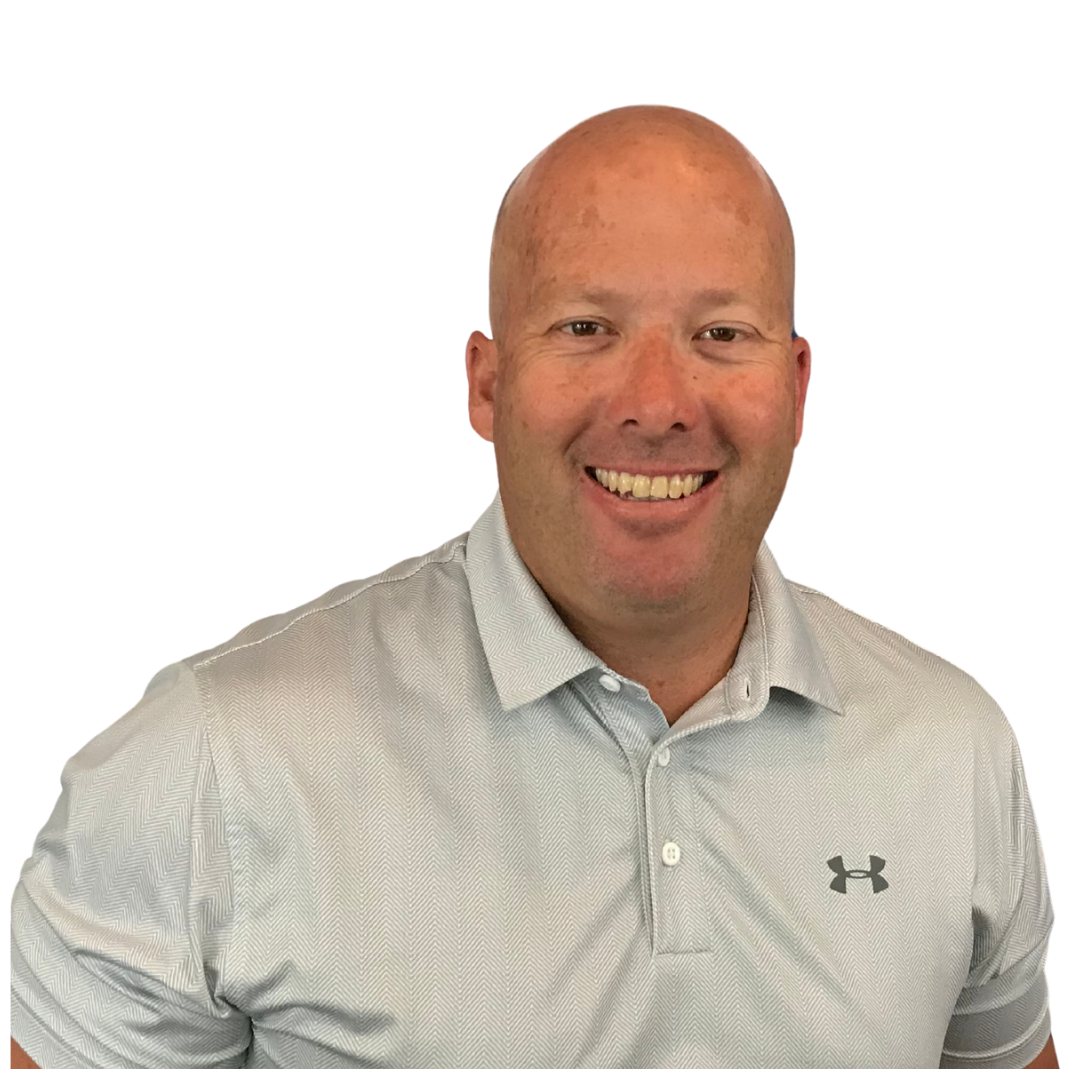 A bald man wearing a under armour shirt is smiling for the camera.