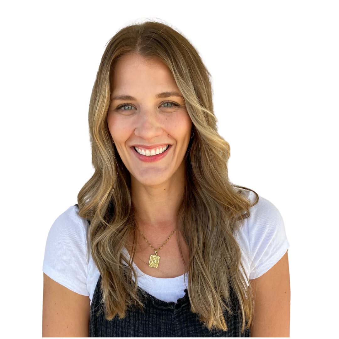 A woman with long hair is smiling for the camera.