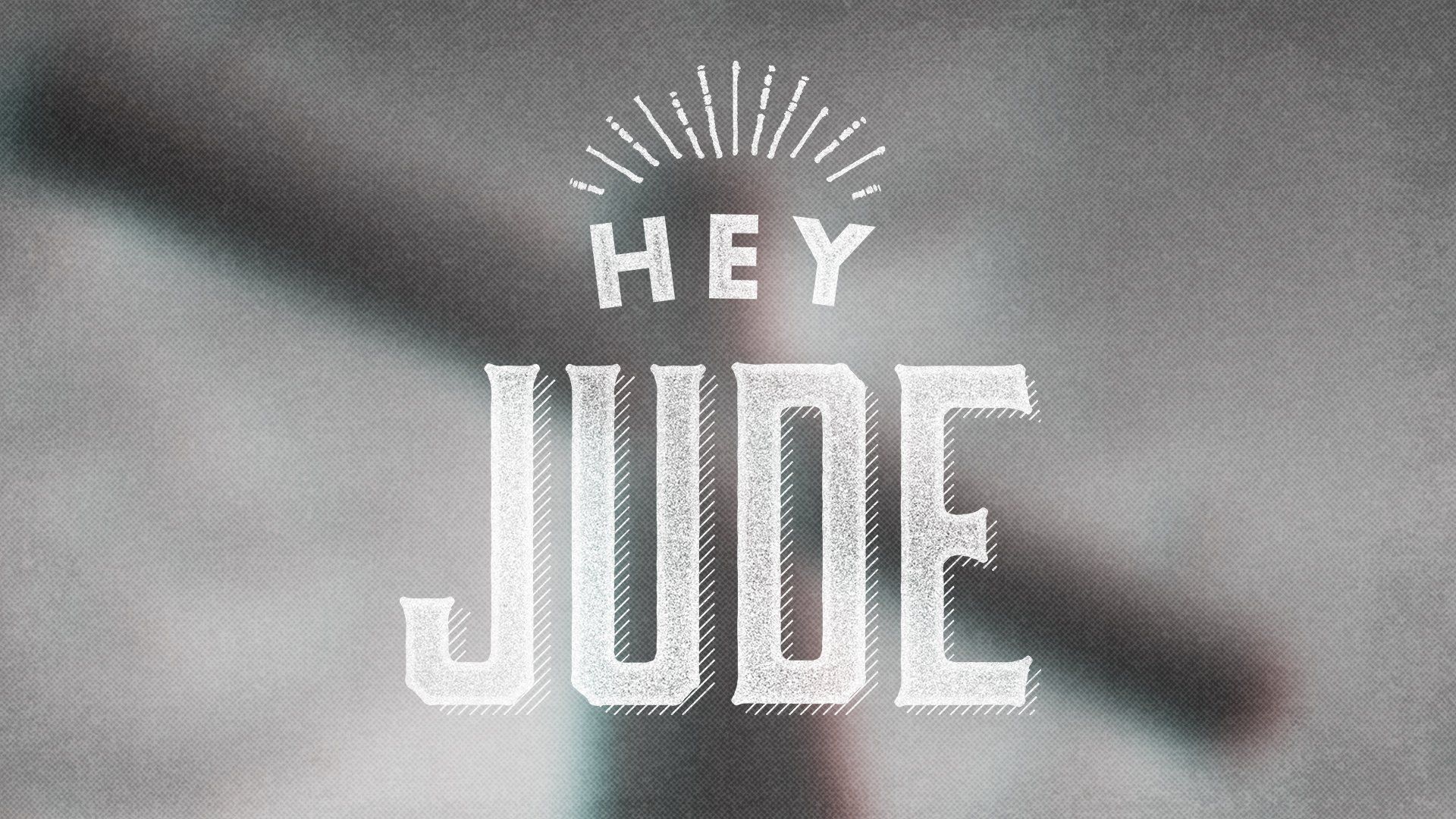 A poster that says hey jude with a cross in the background