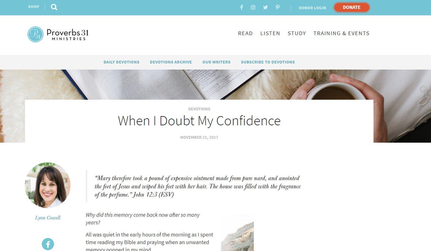 A woman is holding a cup of coffee on a website.
