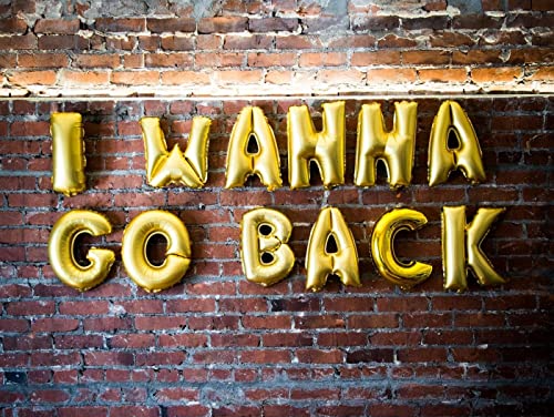 A brick wall with gold balloons that say `` i wanna go back ''