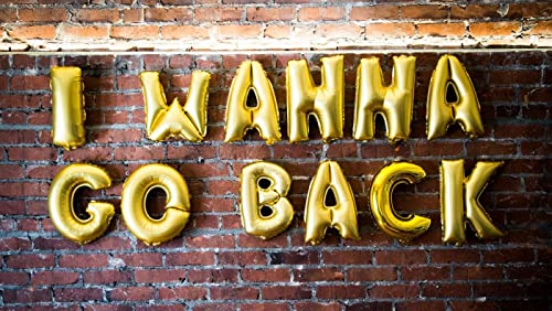A brick wall with gold balloons that say `` i wanna go back ''