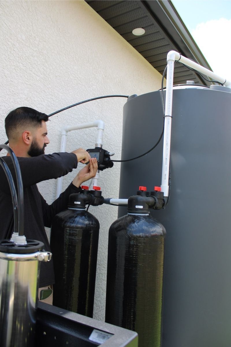 A technician working on a Reverse Osmosis system.