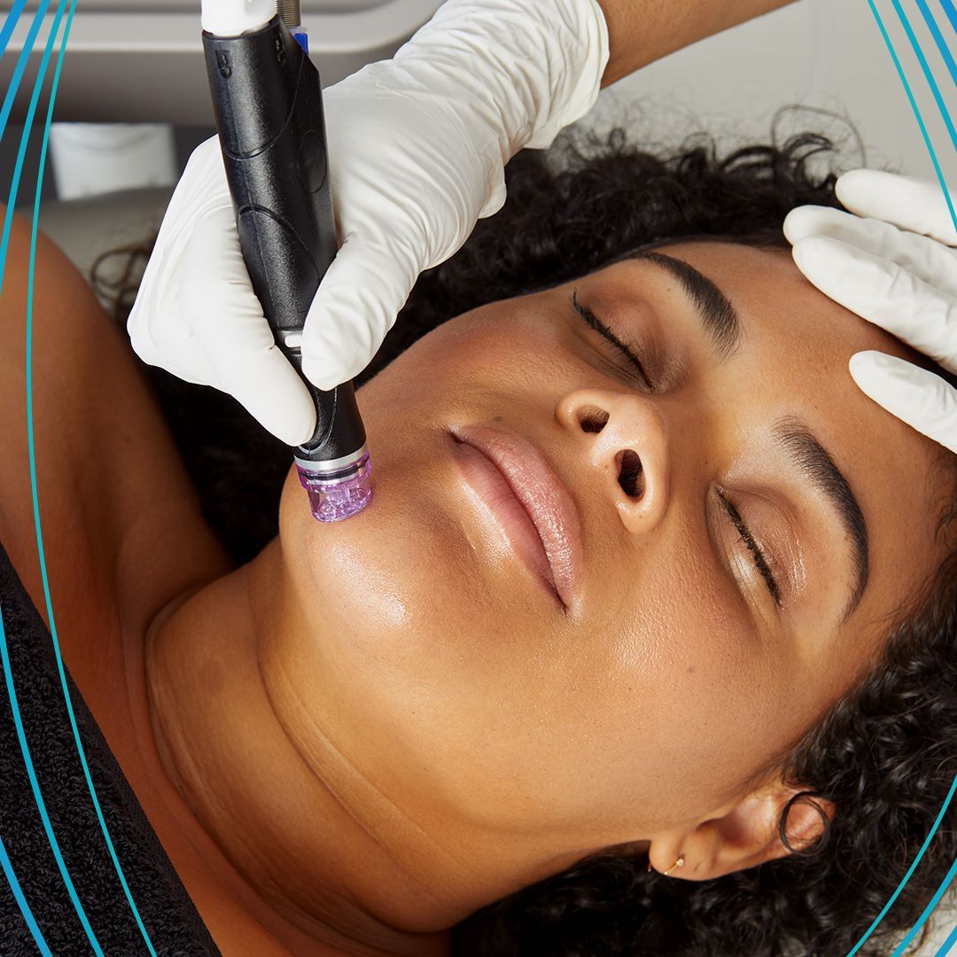 Person receiving facial treatment, lying down with eyes closed, gloved hands hold a skincare device.