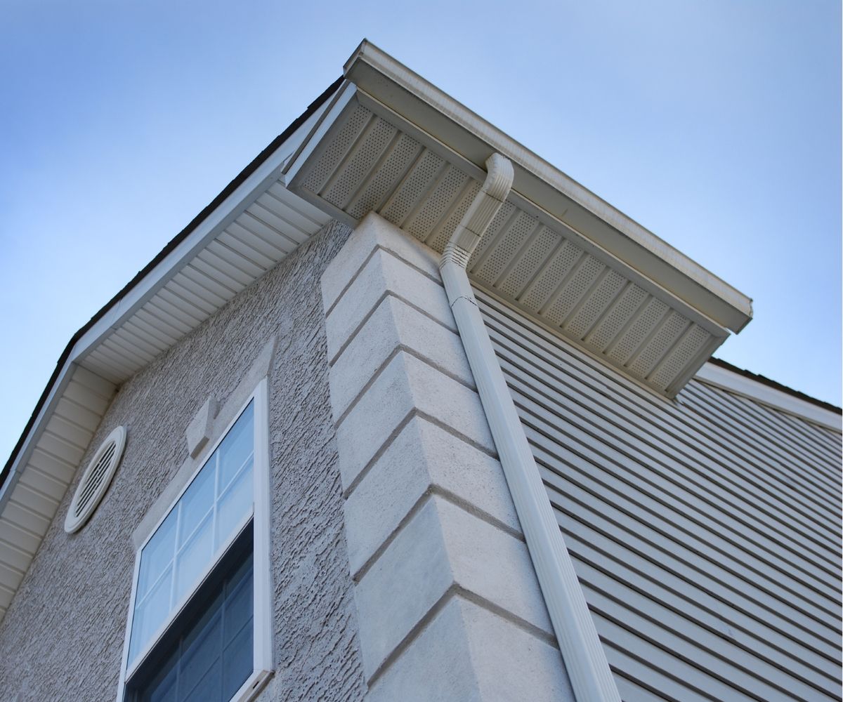Looking up at the roof of a house with a window