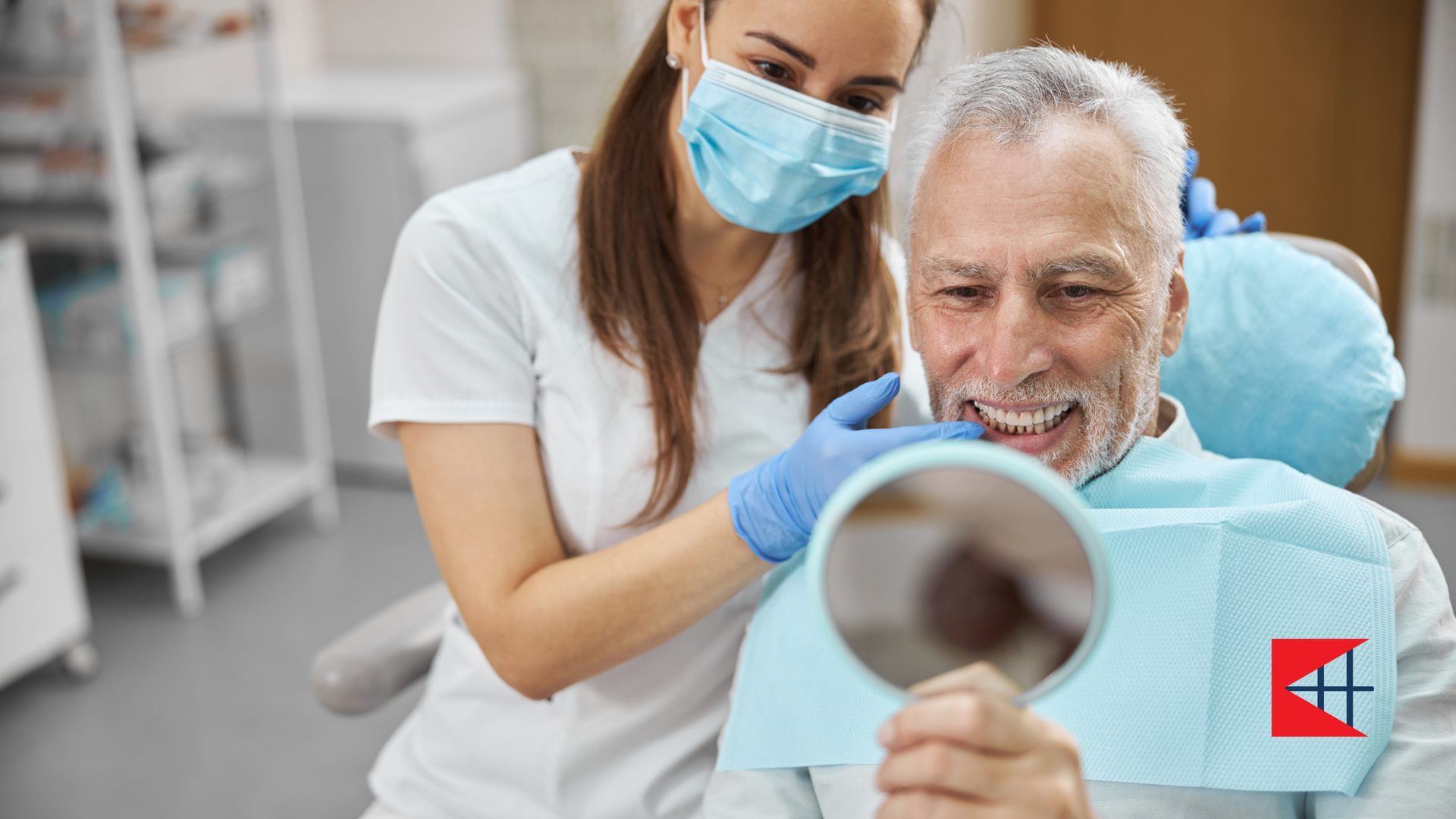 Dentist showing patient his teeth in a mirror. Both are in a dental office.