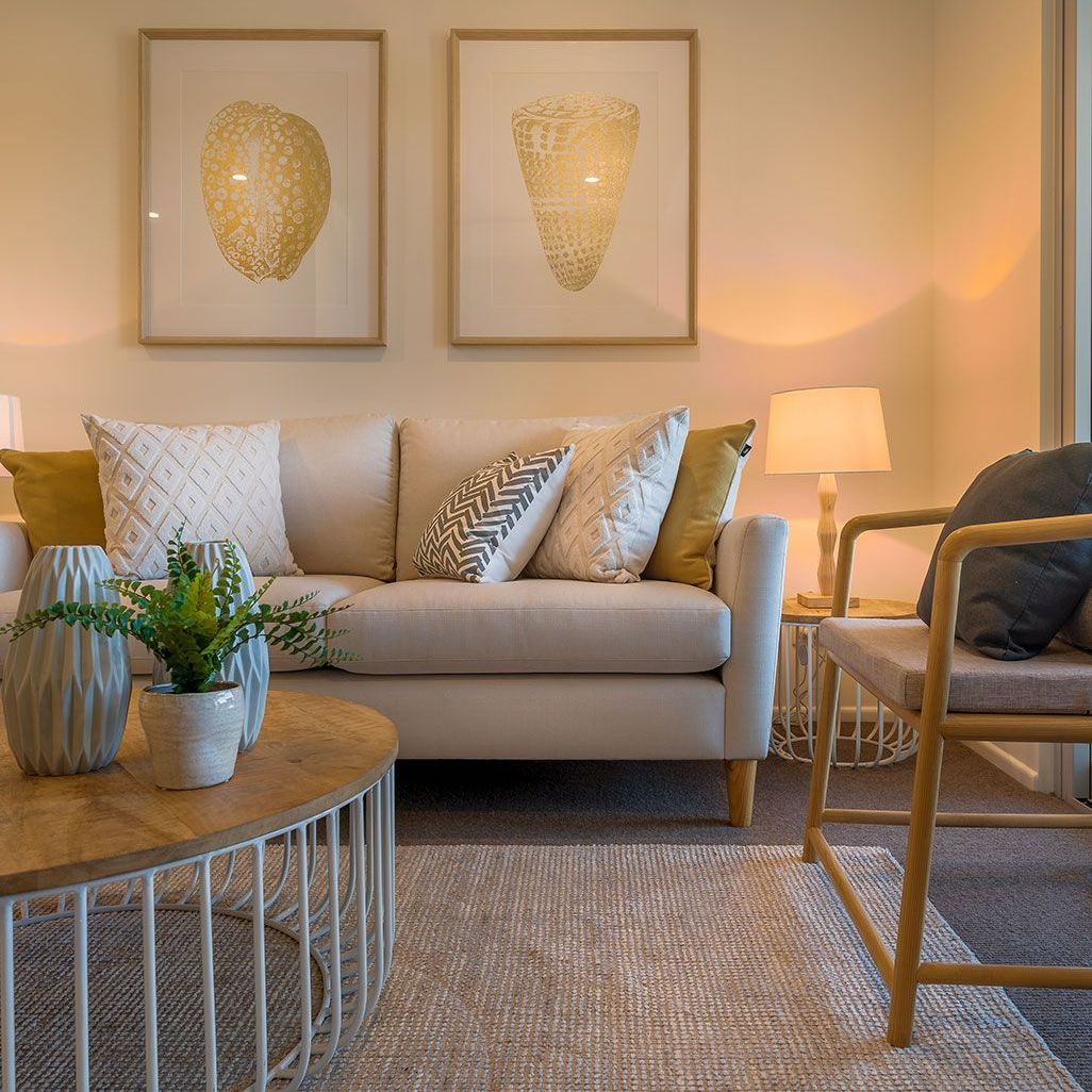 A Living Room With A Couch, Chair, Table And Lamps — Springs Cleaning Supplies In Ciccone, NT