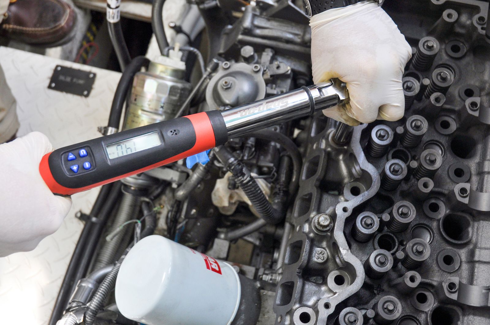 Engine and power tool handled by worker wearing with white gloves