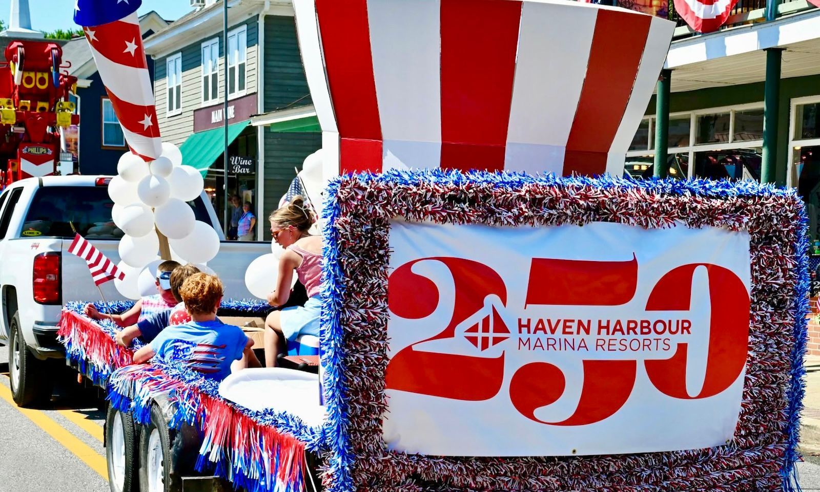 Haven Harbour parade float decorated in red, white and blue and featuring a 250 banner.