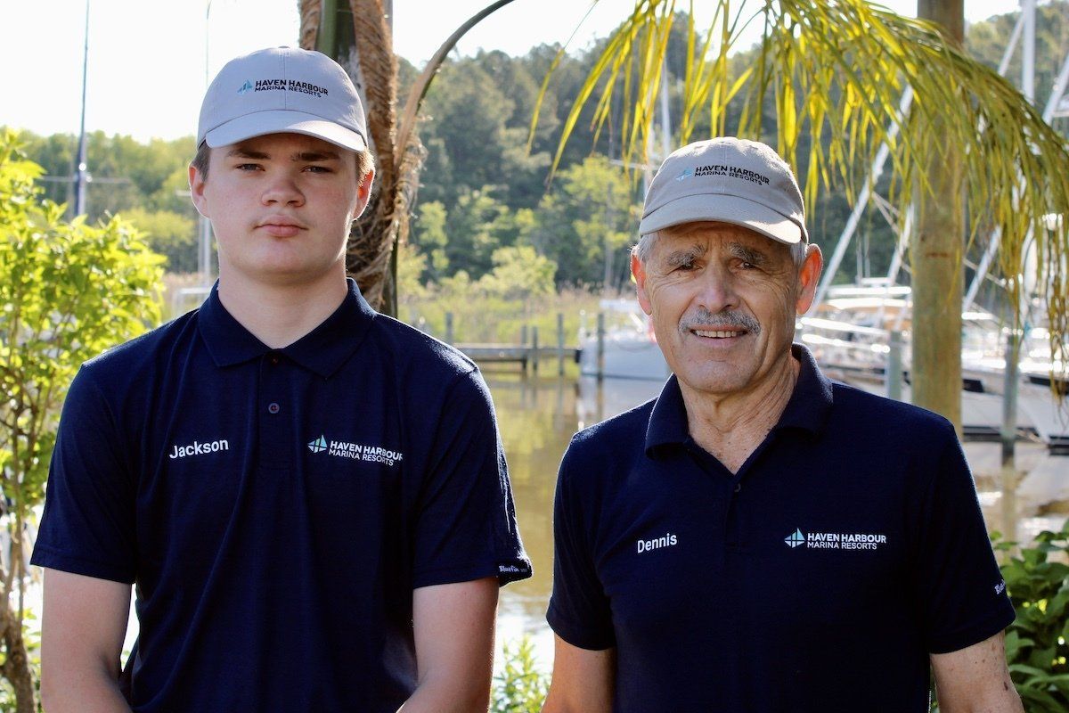 Two employees pictured outside in front of a window