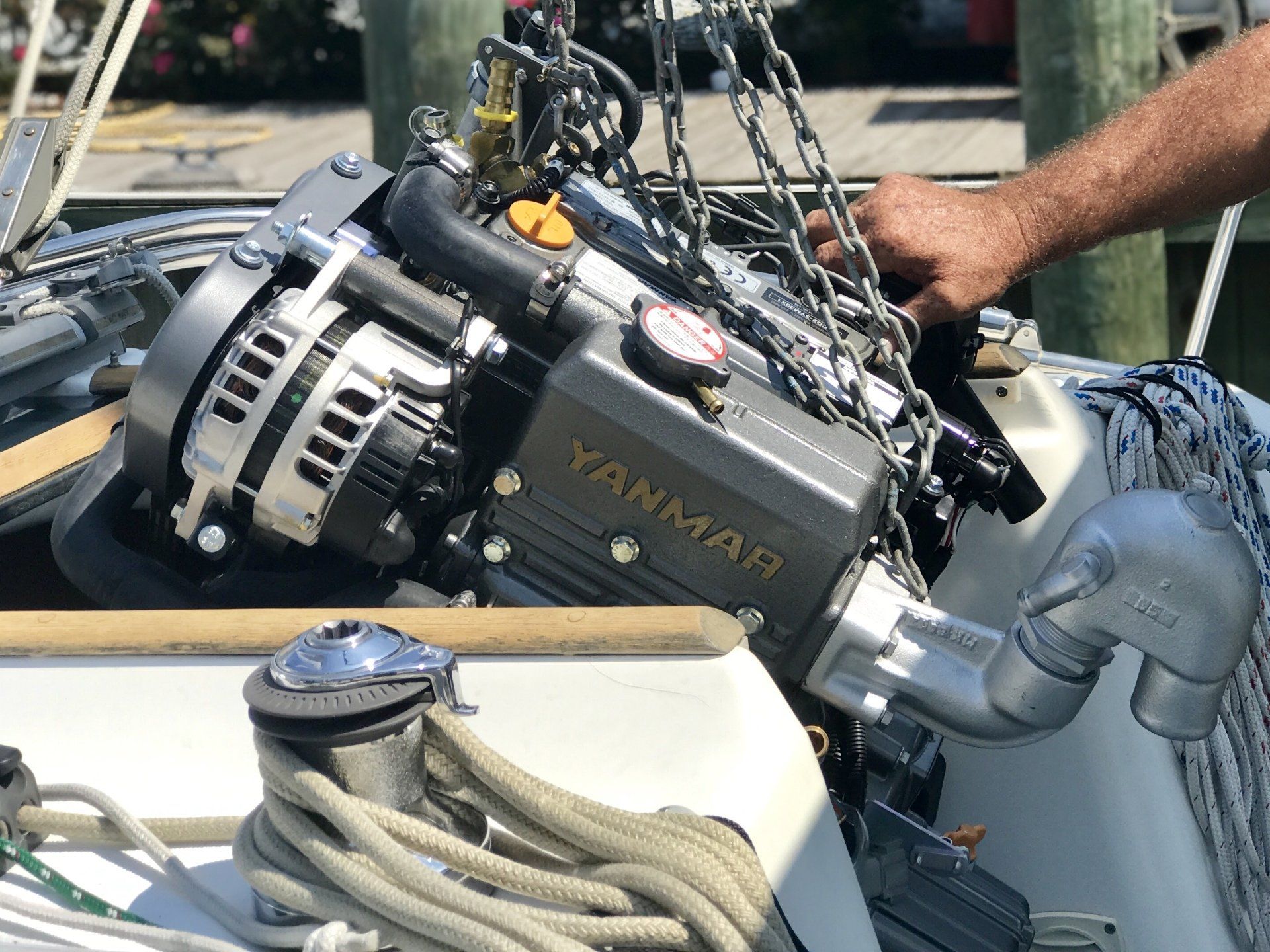 Yanmar engine being installed on boat on sunny day