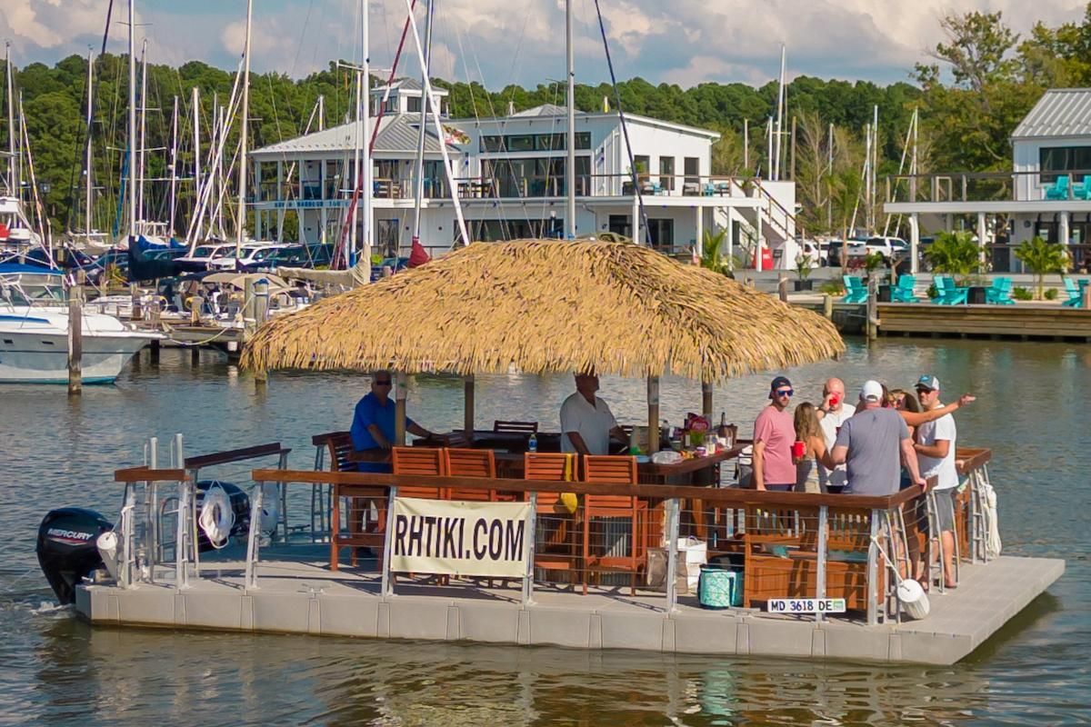Tiki boat with passengers in harbor on sunny day