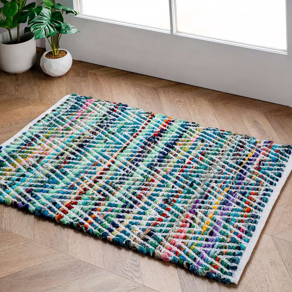 A Colourful Rug is Sitting on a Wooden Floor Next to a Window — Clean Right Carpet Cleaning In Port Macquarie, NSW