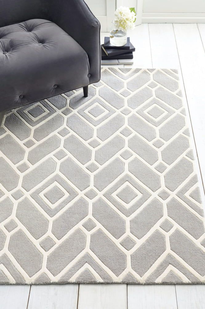 A Gray and White Rug is Sitting on a White Floor Next to a Chair — Clean Right Carpet Cleaning In Port Macquarie, NSW