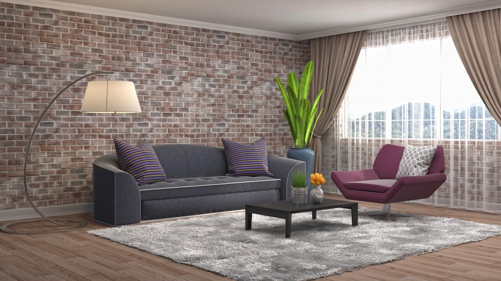 A Living Room With a Couch, Chair, Coffee Table and Brick Wall — Clean Right Carpet Cleaning In Port Macquarie, NSW