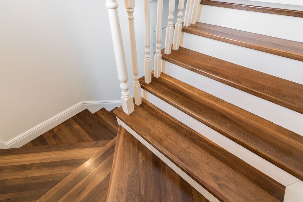 A Close Up of a Wooden Staircase With a White Railing — Clean Right Carpet Cleaning In Port Macquarie, NSW