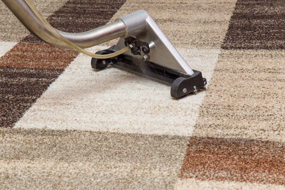 A Vacuum Cleaner is Cleaning a Checkered Carpet — Clean Right Carpet Cleaning In Port Macquarie, NSW