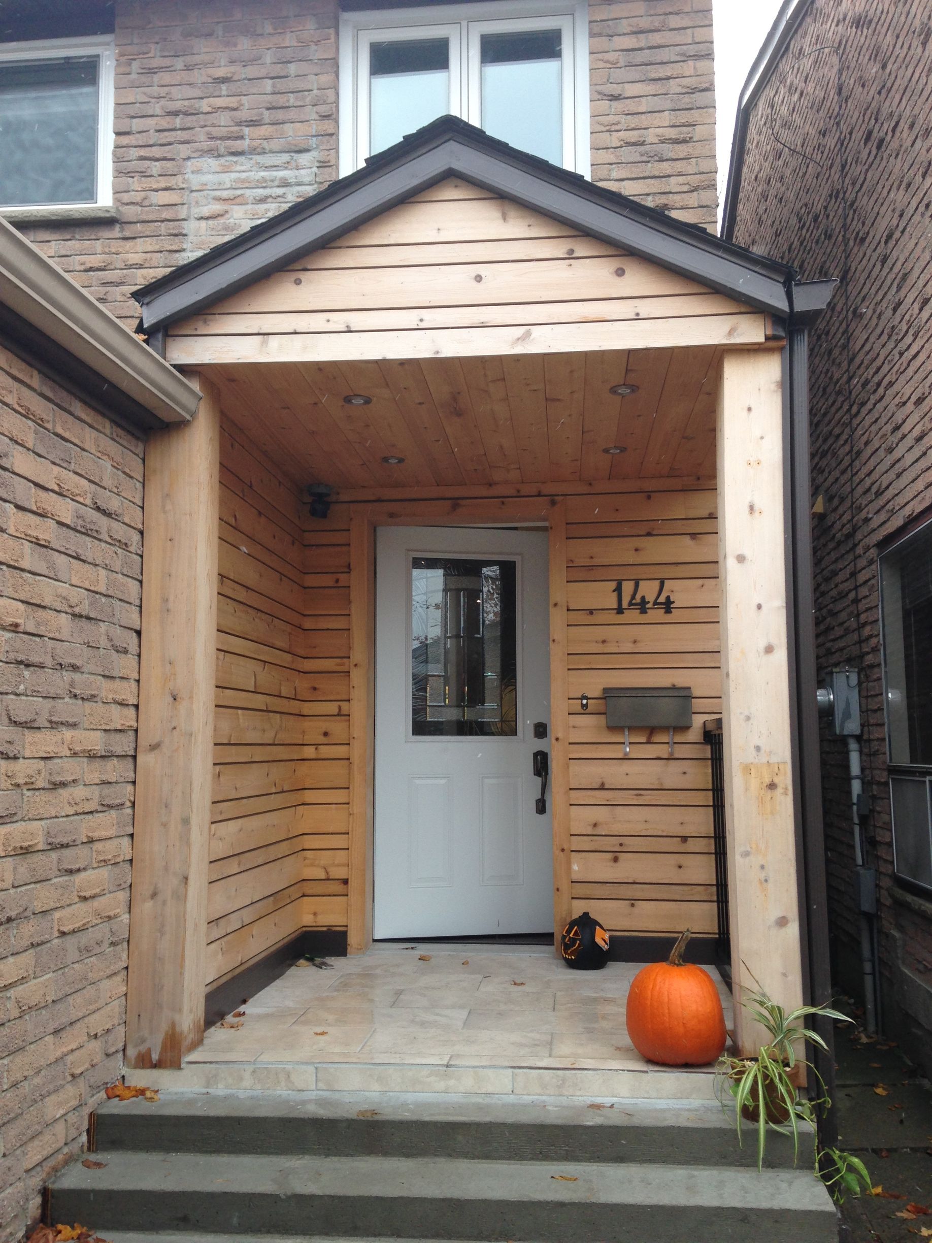The front door of a house with the number 164 on it