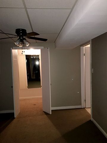 There is a ceiling fan in the corner of the room.