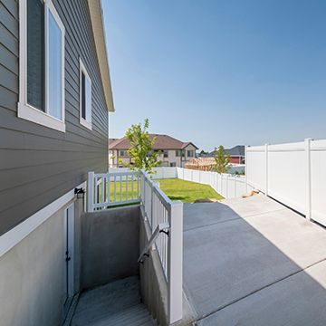 There is a ramp leading up to the basement of a house.