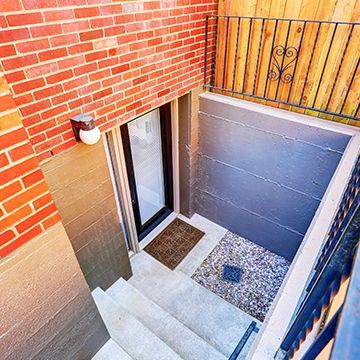 An aerial view of a basement with stairs leading up to it.