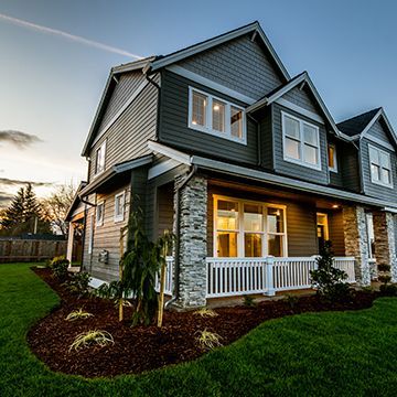 A large house with a lot of windows and a porch.