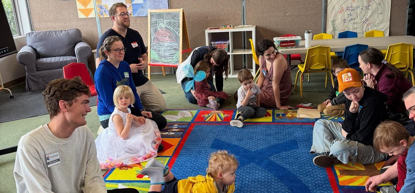 A group of children are sitting on the floor in a church.