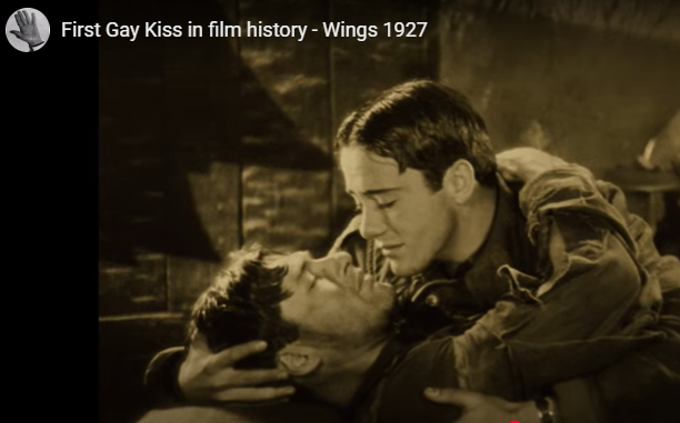 Sepia-toned scene of two people kissing in a vintage film still, with title text in the corner