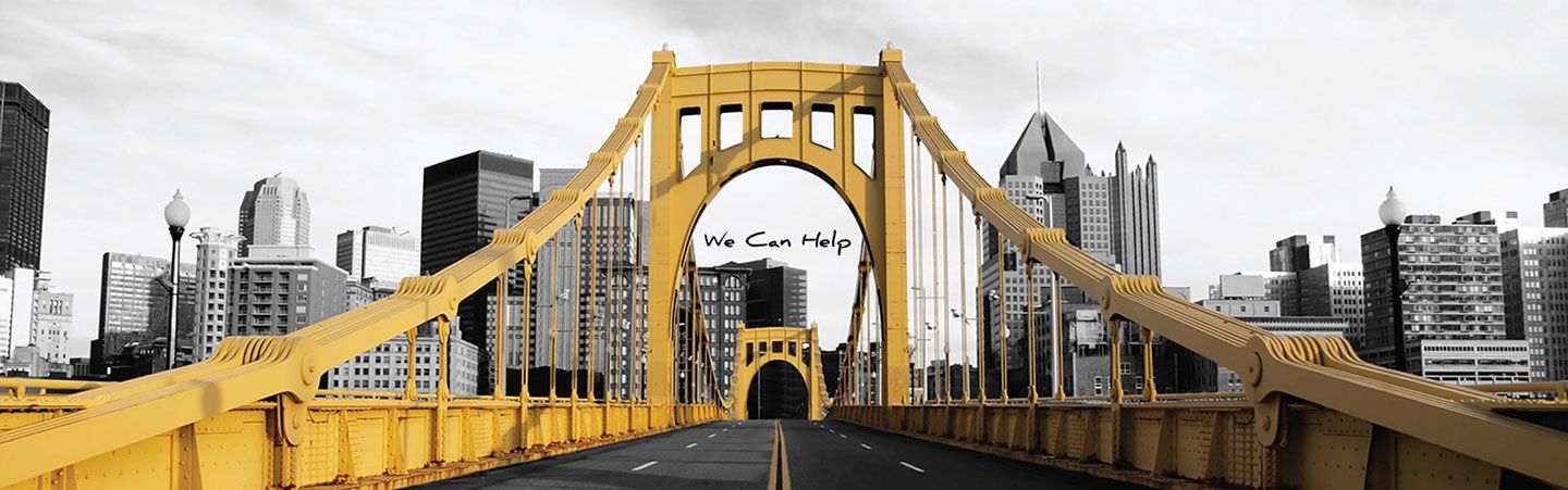 A yellow bridge with a city skyline in the background.