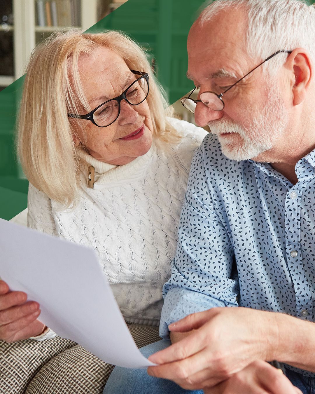 Older couple reviewing documents together, discussing wills and estate planning at home